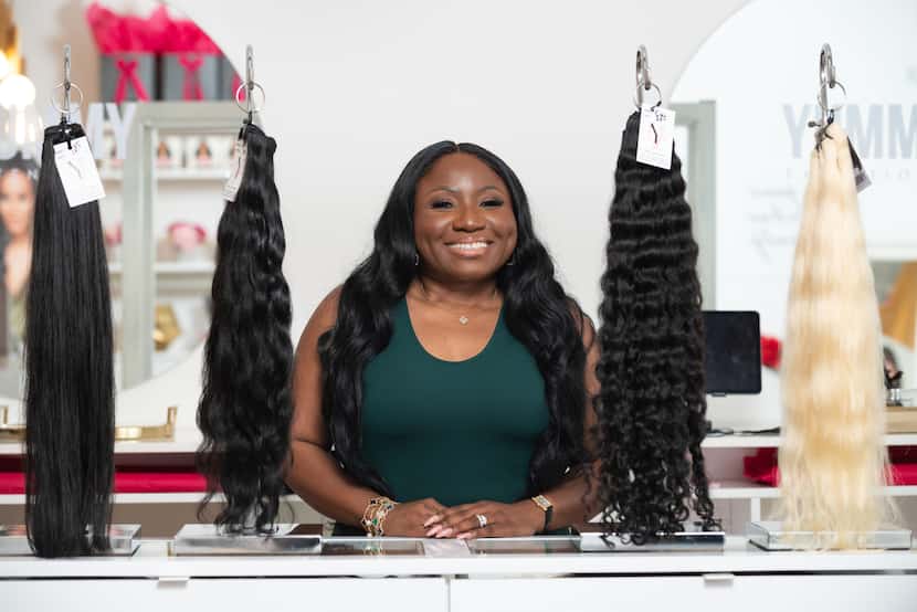 Yummie O., founder and CEO of Yummy Extensions, is shown at her shop in Dallas on Nov. 9....