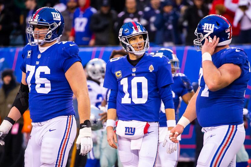 New York Giants quarterback Eli Manning (10) walks off the field after turning the ball over...