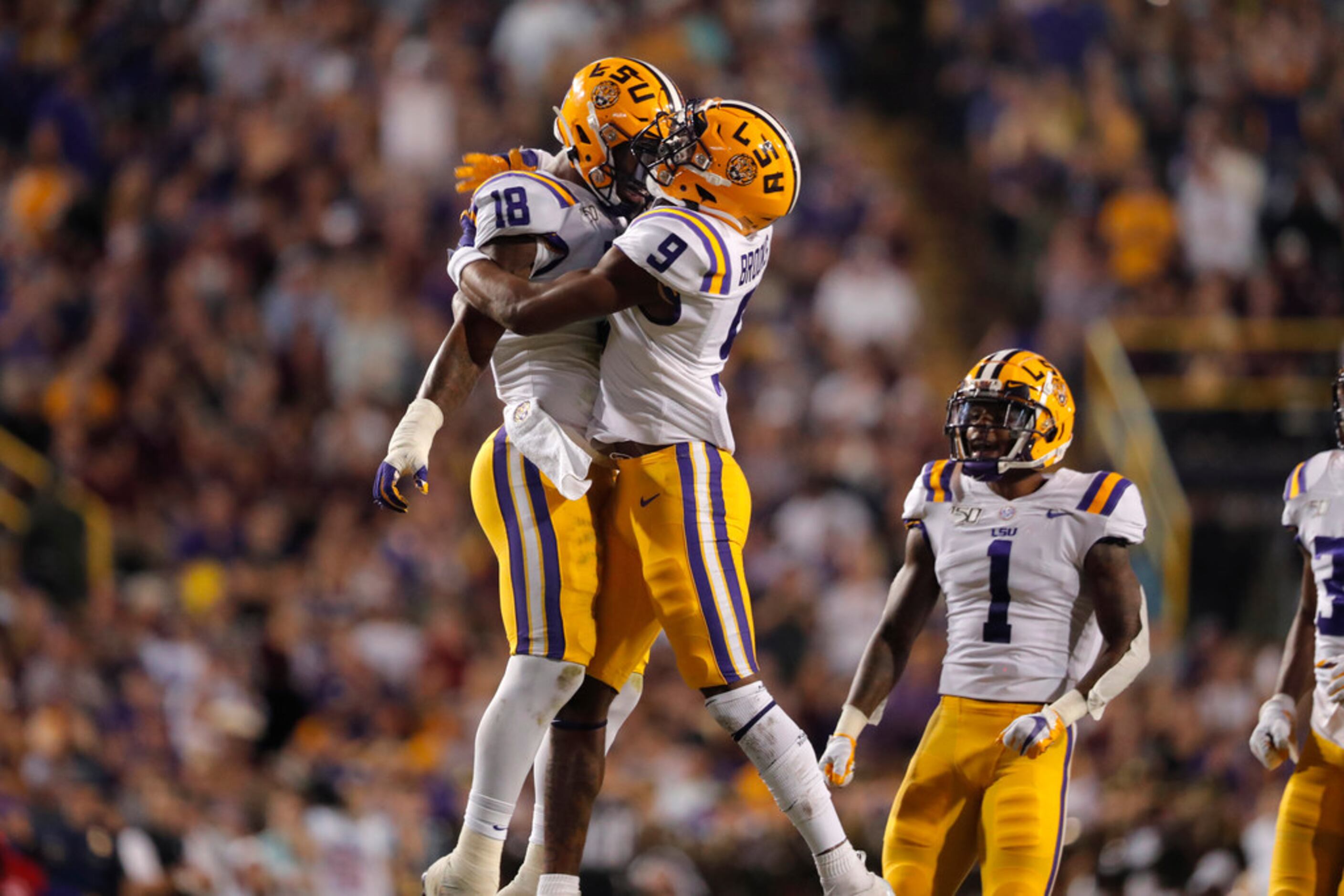 LSU safety Marcel Brooks (9) and linebacker K'Lavon Chaisson (18) celebrate a sack during...