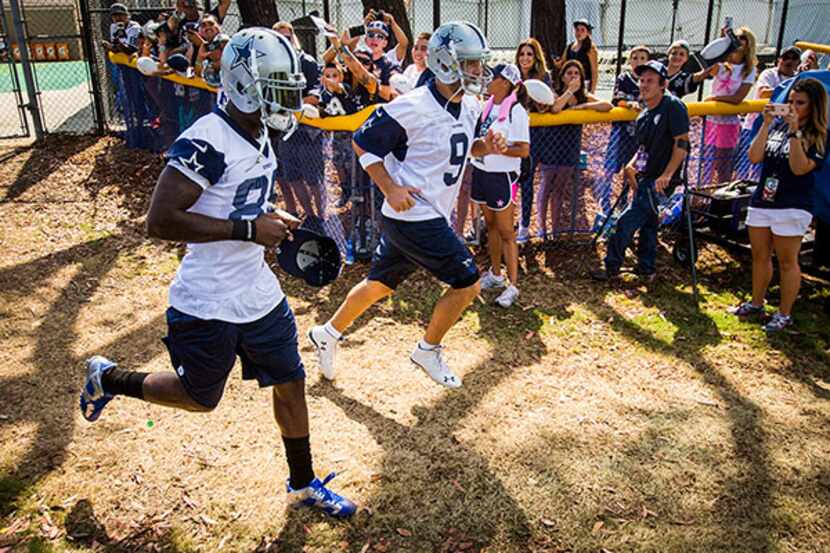 Dez Bryant (left) and Tony Romo take the field for the first afternoon practice in Oxnard,...