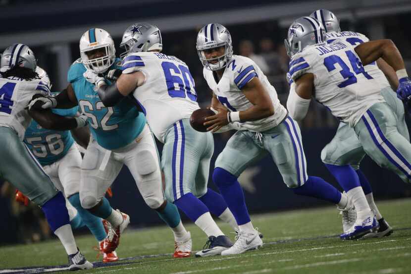 Dallas Cowboys quarterback Jameill Showers (7) hands the ball off during their game against...