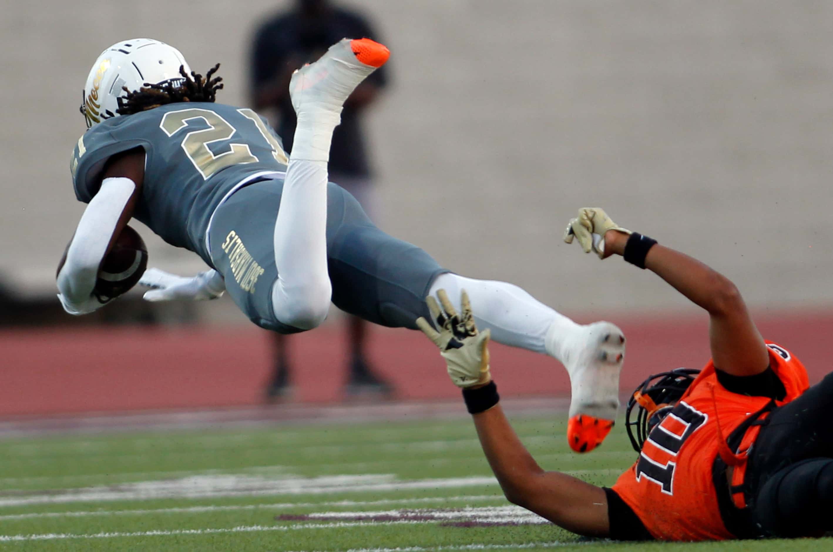 South Oak Cliff running back Danny Green (21) is tripped up with a touchdown saving tackle...