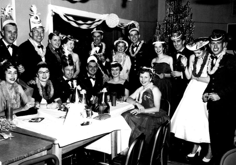 Larry and Jo Whitford (both far left) with other officers and their wives at a party in an...