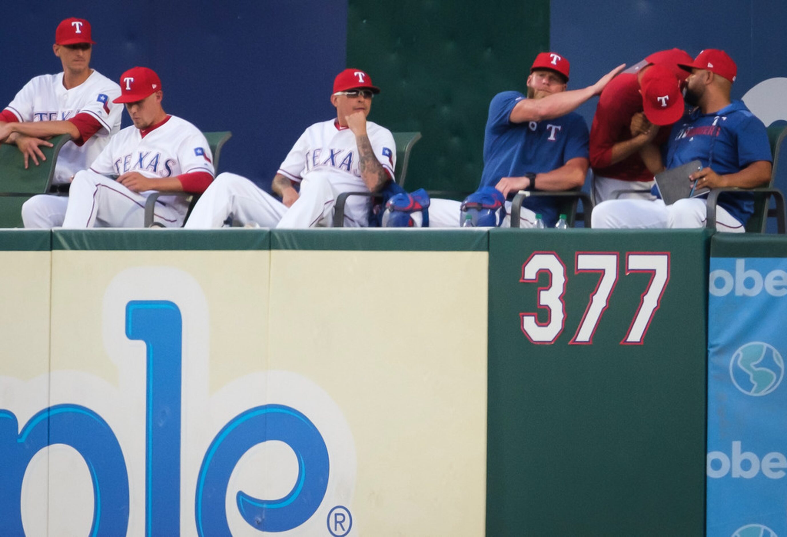 Texas Rangers relief pitcher Chris Martin (at right in red) says goodbye to bullpen coach...