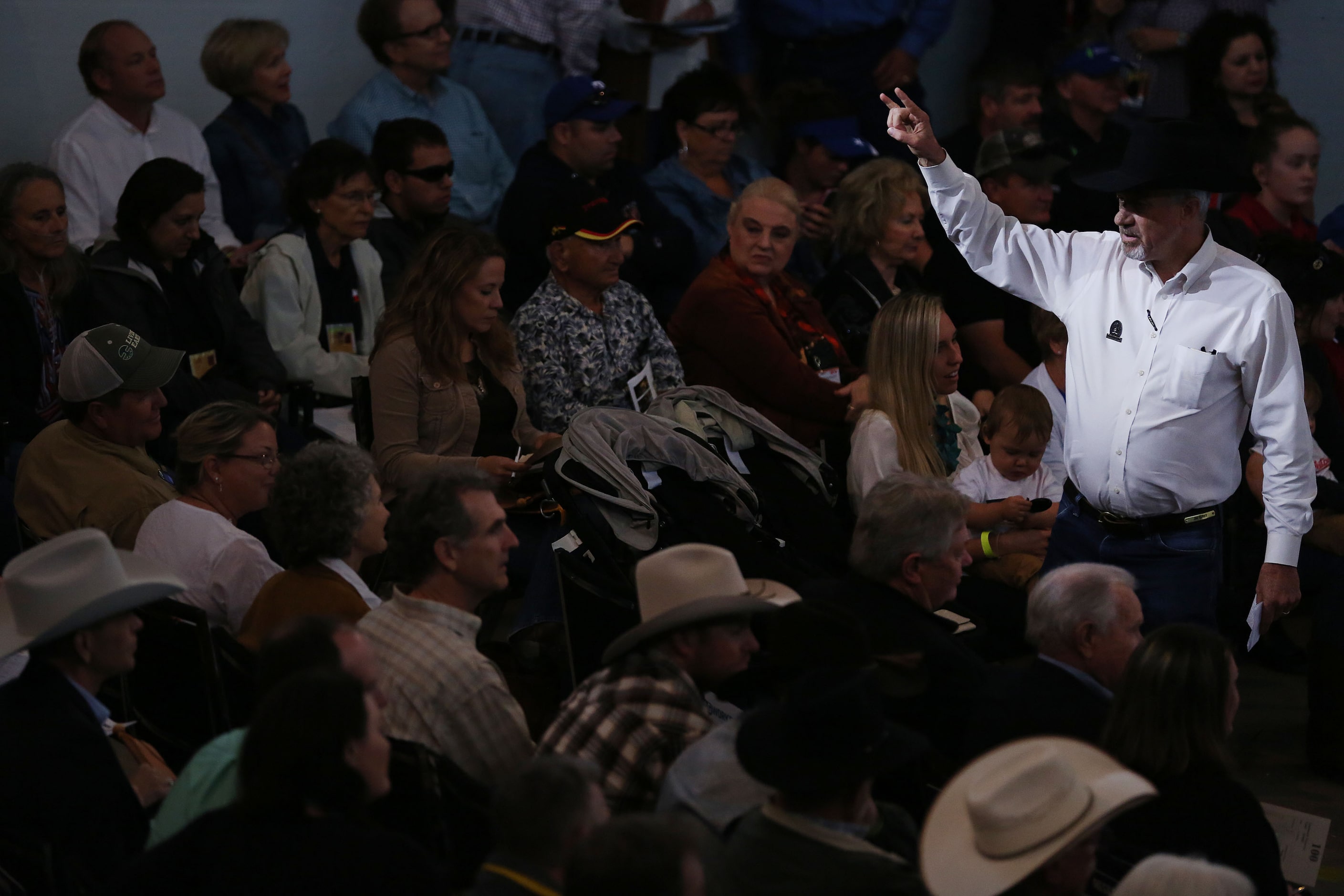 A auctioneer helps to collect bids during the State Fair of Texas Youth Livestock Auction at...