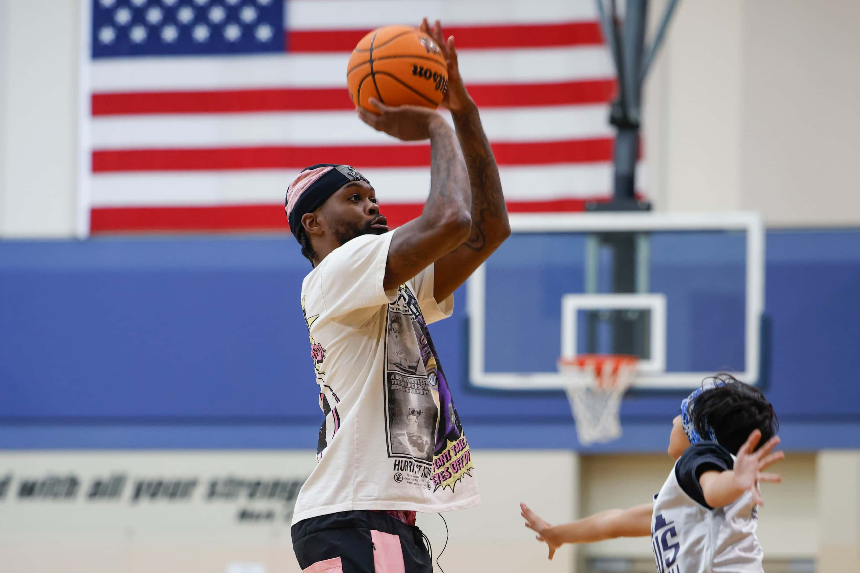 Dallas Mavericks’ Naji Marshall, play ball with young basketball campers during a Hoop Camp,...