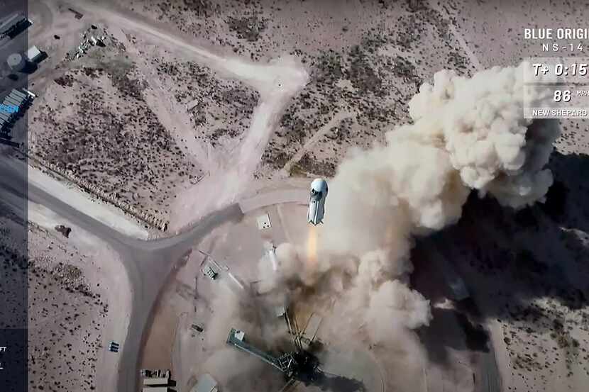 This frame grab from Blue Origin's livestream Thursday shows its New Shepard rocket blasting...