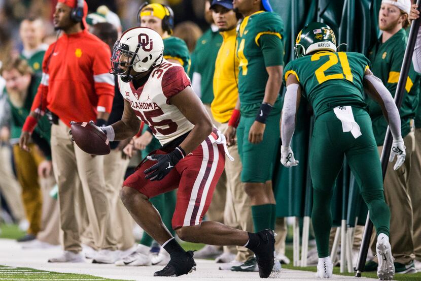 Oklahoma Sooners linebacker Nik Bonitto (35) is tackled by Baylor wide receiver Josh Fleeks...