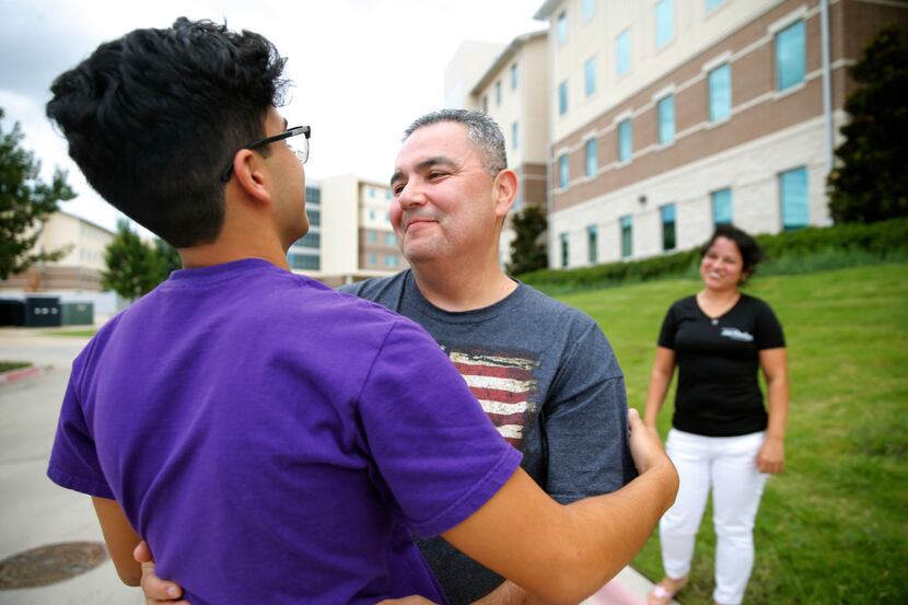 Joaquin Jimenez says goodbye to son Erik Jimenez, 18, after helping him move into his new...