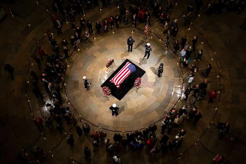 Public visitors pass by the flag-draped casket of President George H.W. Bush  in the Rotunda...