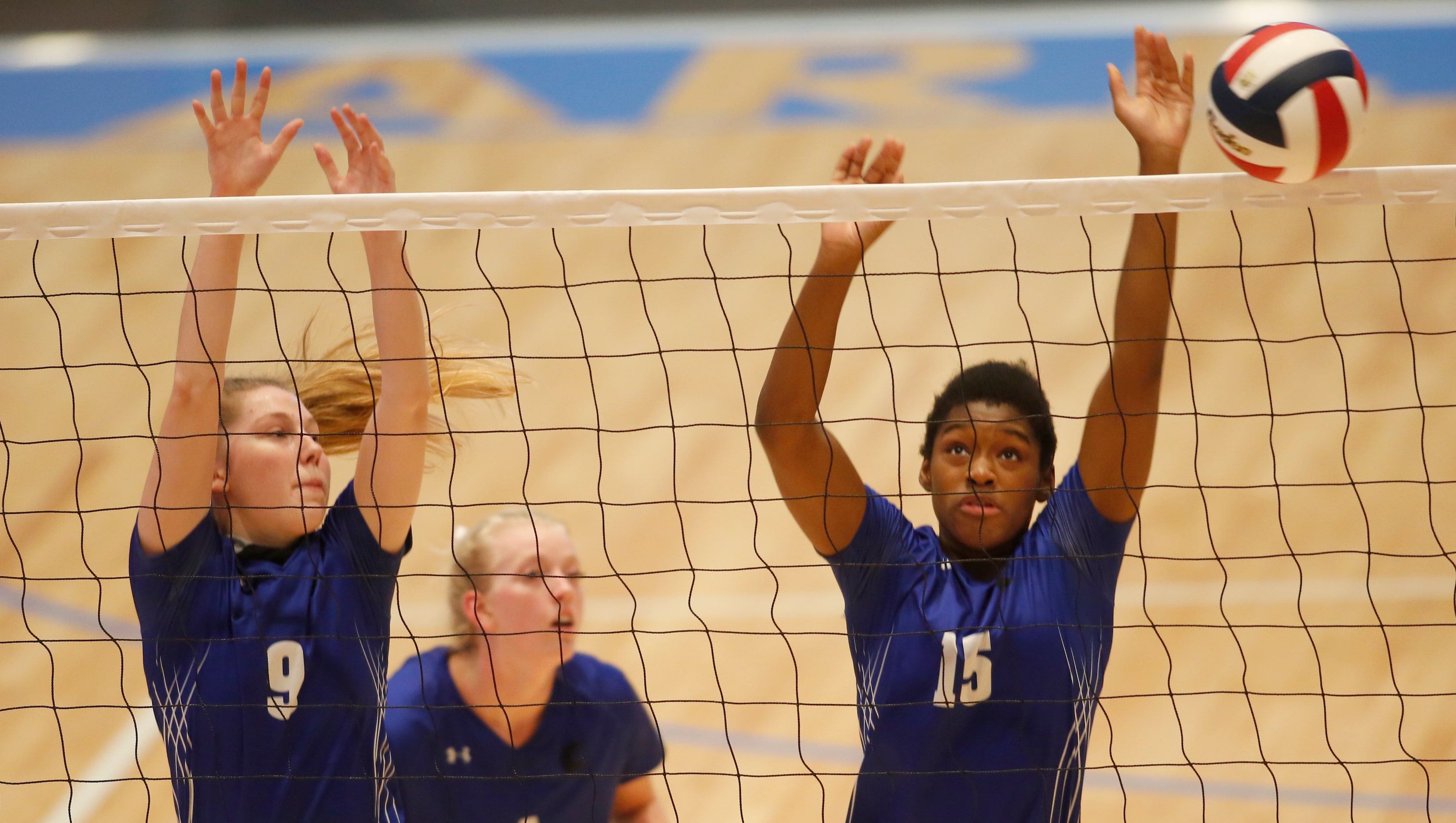 Denton Guyer's Joanne Oigbokie (15) leaps alongside teammate Bailey Samide (9) as the pair...