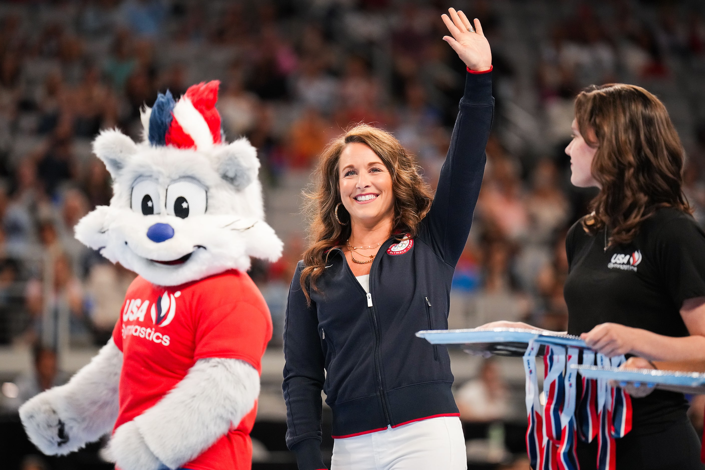 2004 Olympic all-around gold medalist Carly Patterson waves to the crowd before presenting...