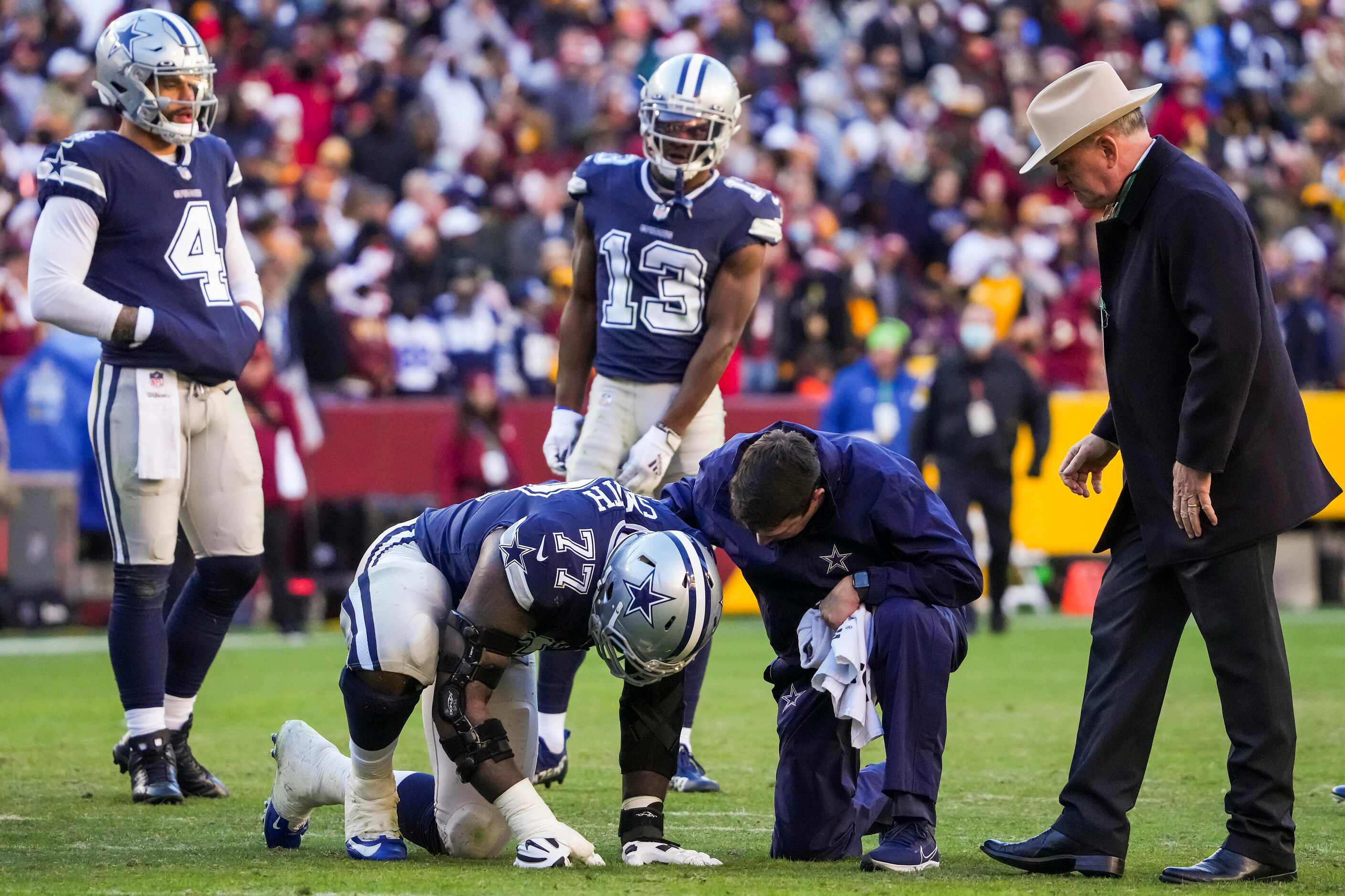 Dallas Cowboys offensive tackle Tyron Smith (77) receives attention after being injured...