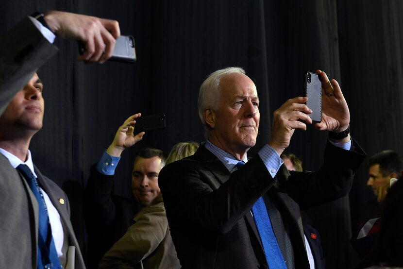 Sen. John Cornyn, R-Texas, listens as President Donald Trump speaks during a rally in El...