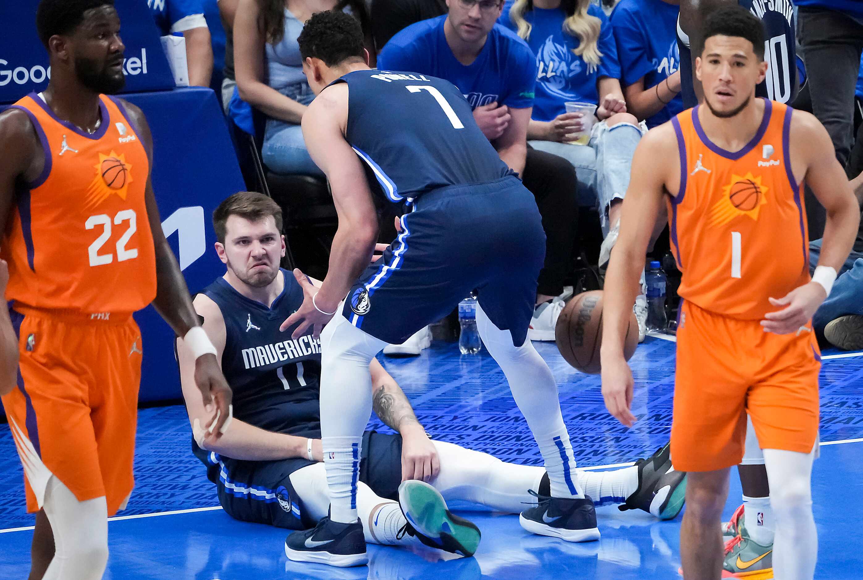 Dallas Mavericks guard Luka Doncic (77) stares back at Phoenix Suns guard Devin Booker (1)...