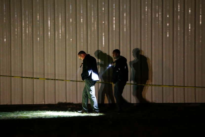 Investigators worked the crime scene after a shooting at the Party Venue on Highway 380 in...