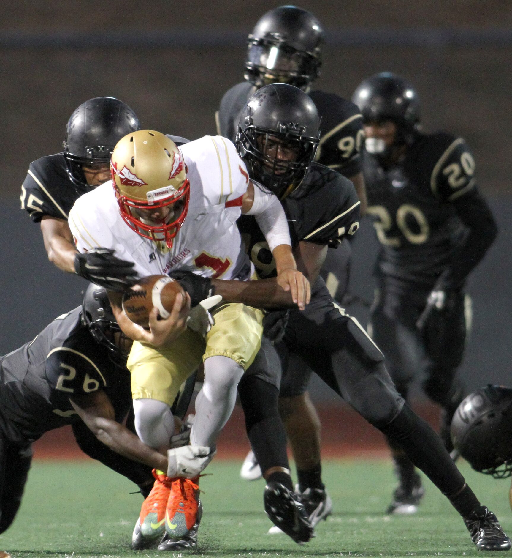 South Grand Prairie quarterback Greg Eisworth (11) draws the attention of the South Oak...