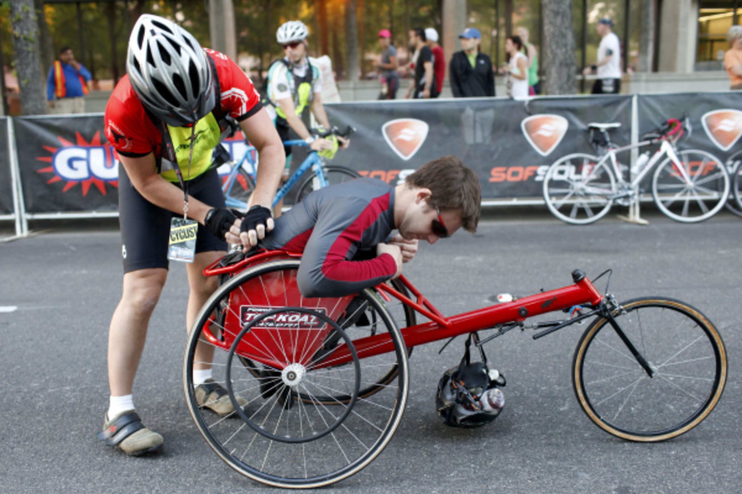 Keith Townsend of Ft. Worth helps wheelchair racer Don Rock adjust in his seat before...