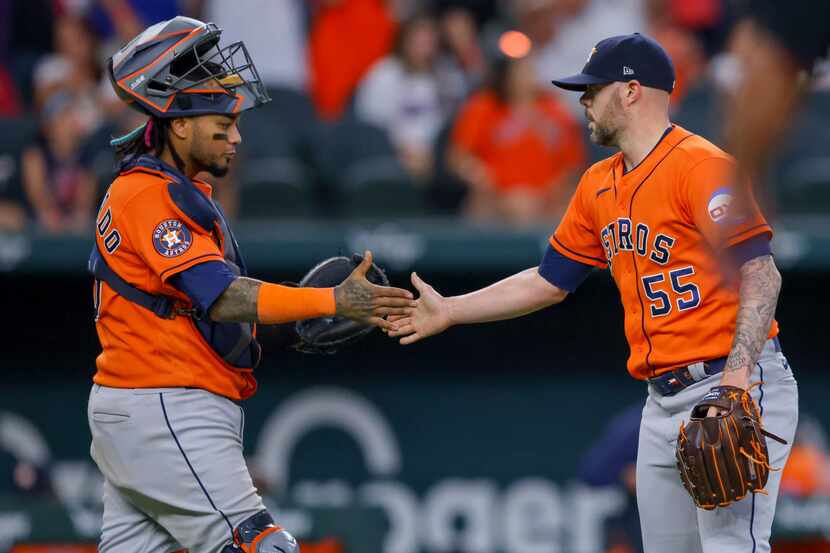 Houston Astros' Martín Maldonado, left, and Ryan Pressly shake hands after the final out of...
