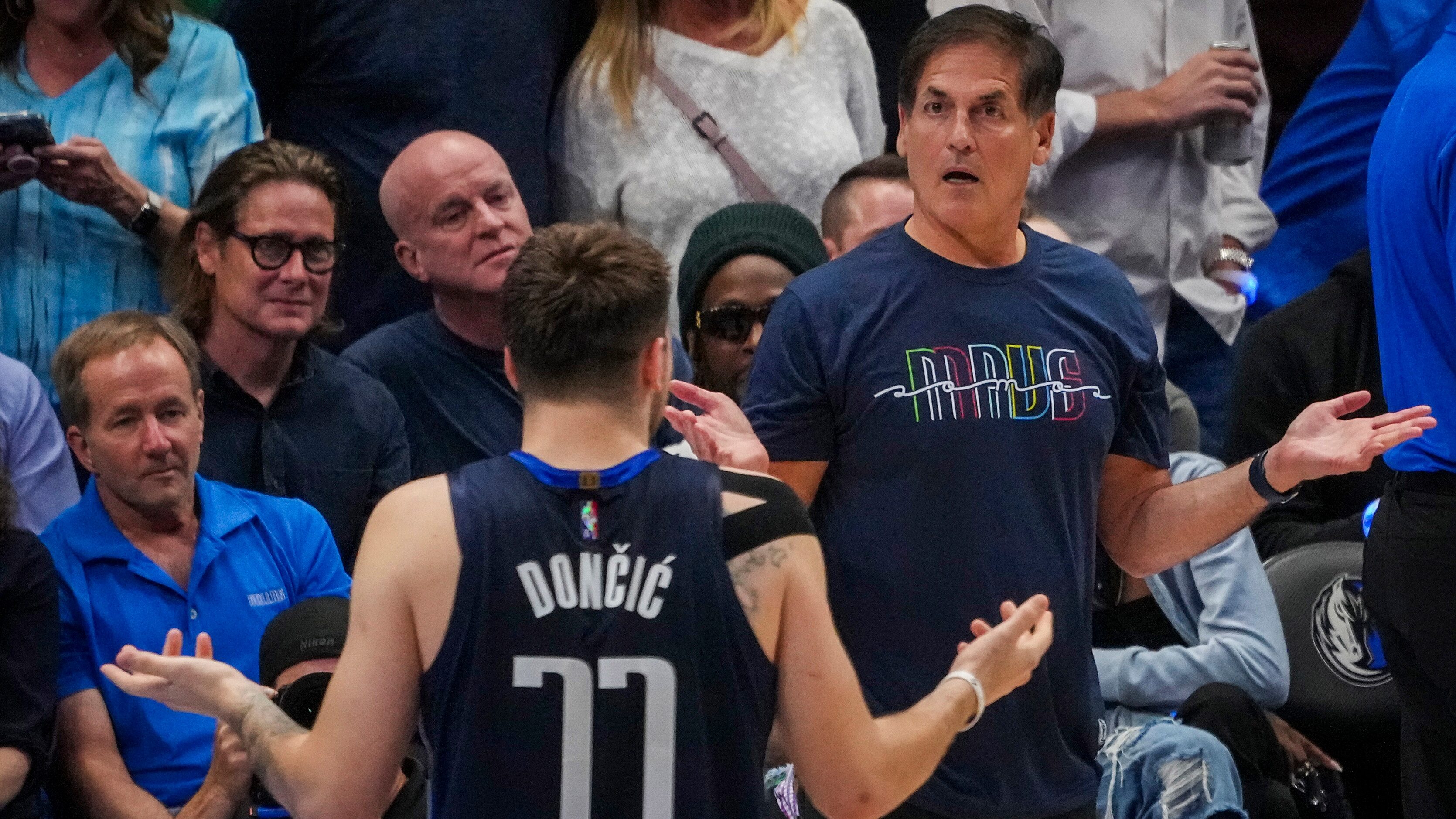 Dallas Mavericks guard Luka Doncic  and owner Mark Cuban react after an offensive foul call...