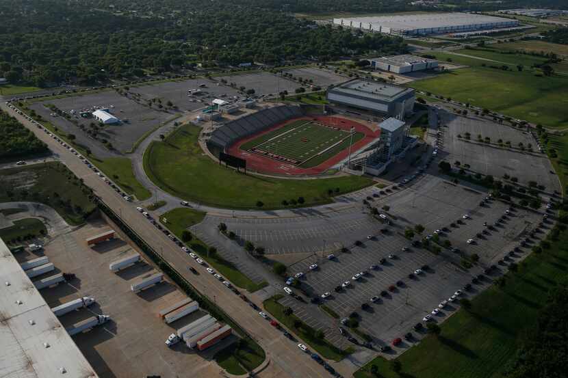 Hundreds of cars weave around the Ellis Davis Field House coronavirus testing site on Friday.