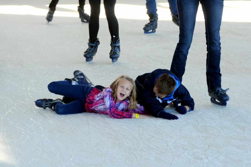 A skater falls on the slick ice at Panther Island Ice at Coyote Drive-In in Fort Worth, TX...