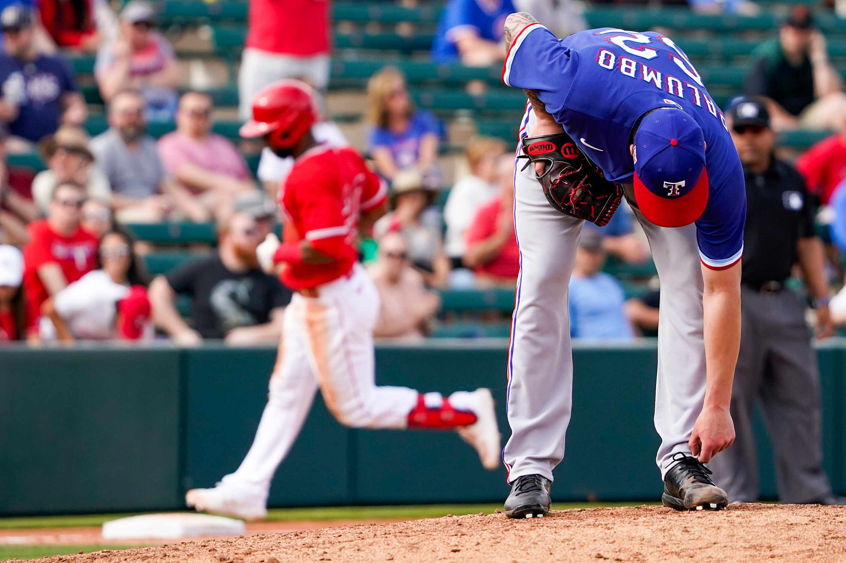 Texas Rangers pitcher Joe Palumbo collects himself as Los Angeles Angels shortstop Arismendy...