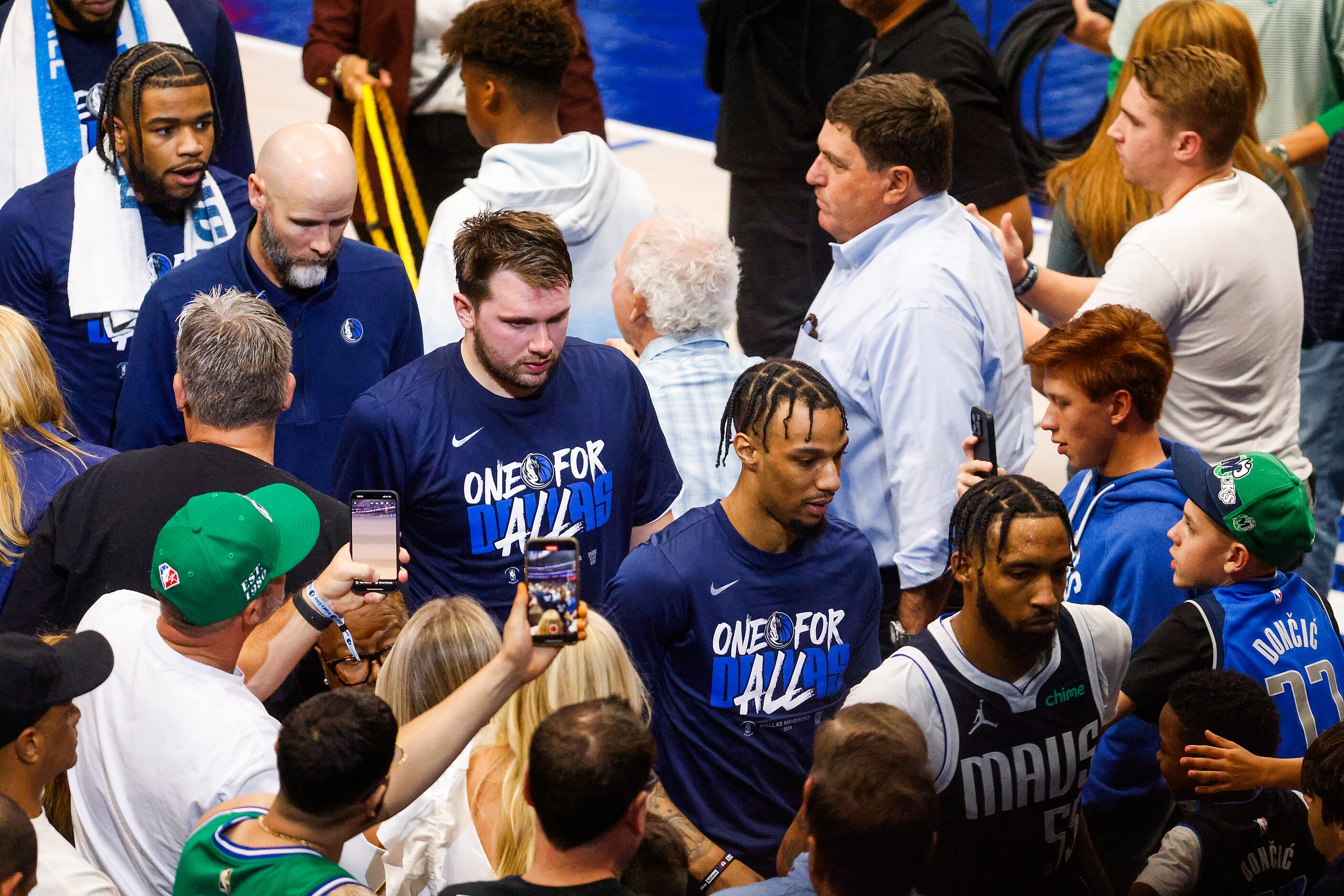 Dallas Mavericks players leave the court after the first half of an NBA basketball...