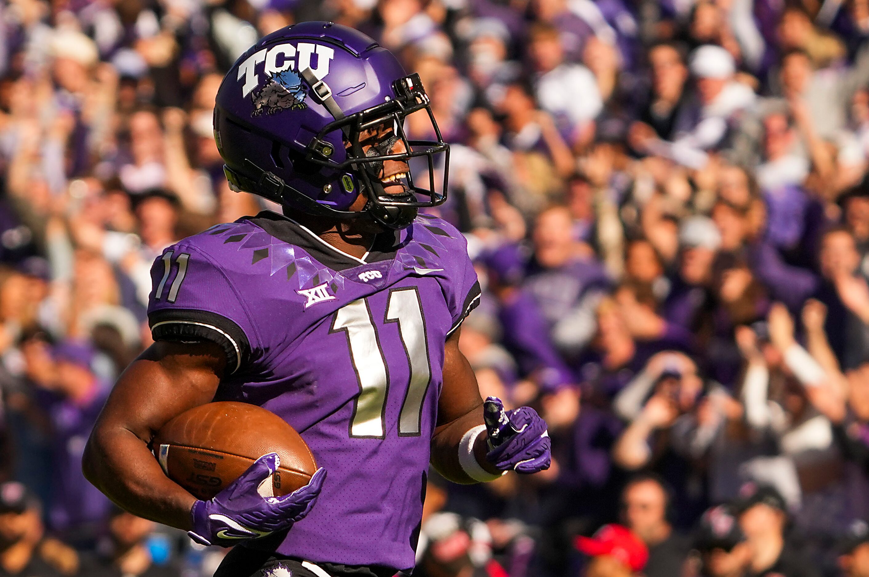 TCU wide receiver Derius Davis (11) races downfield on an 82-yard punt return for a...