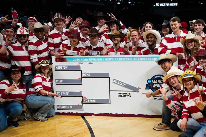 The North Carolina State band poses with the regional bracket following a victory over Duke...