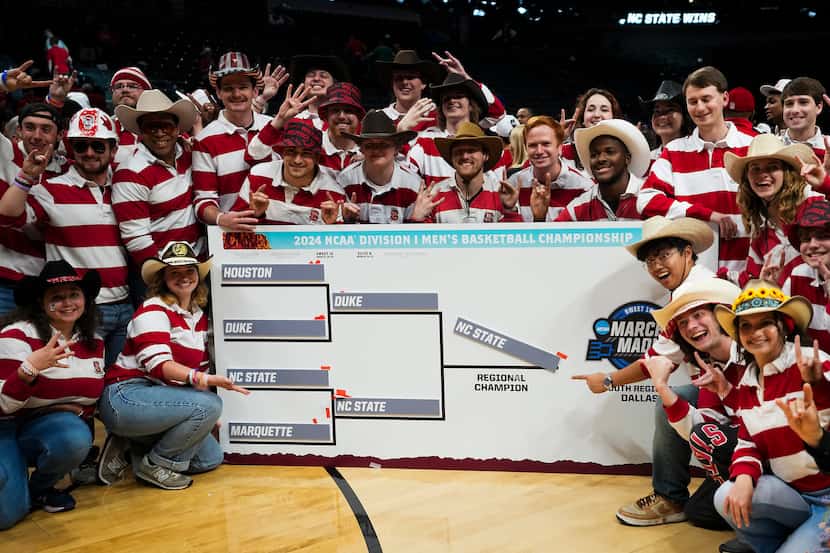 The North Carolina State band poses with the regional bracket following a victory over Duke...