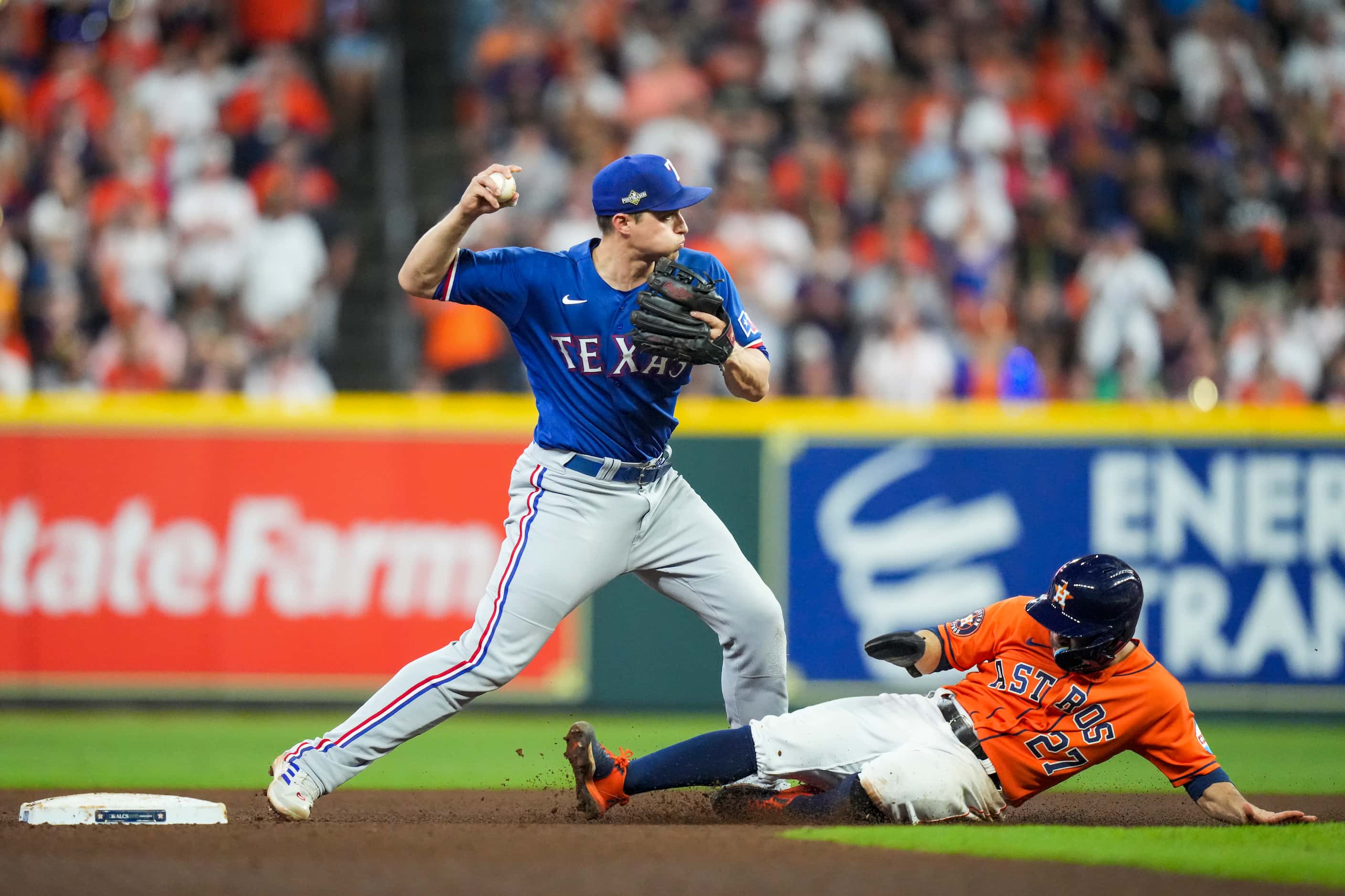 Texas Rangers shortstop Corey Seager turns an inning-ending double play over Houston Astros...