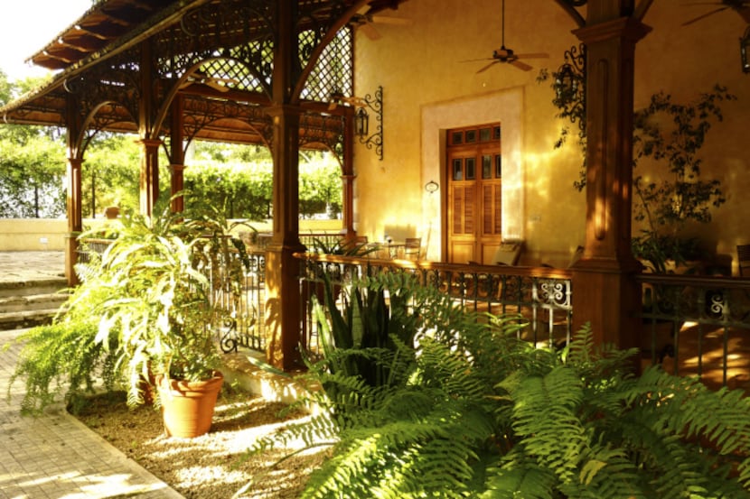 Lounge chairs in shady verandahs face the gardens at Hacienda Xcanatún.