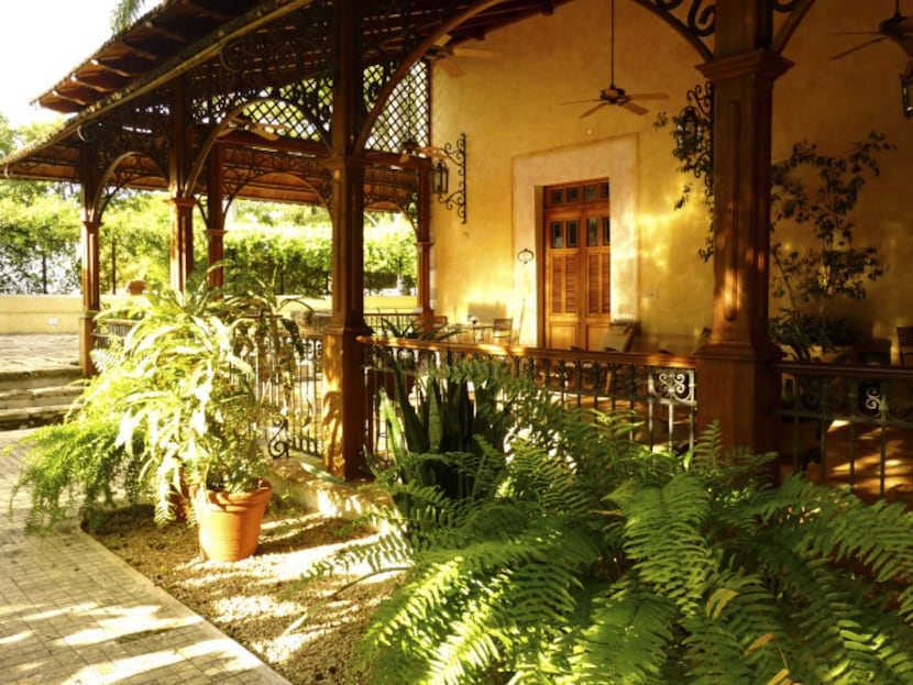 Lounge chairs in shady verandahs face the gardens at Hacienda Xcanatún.