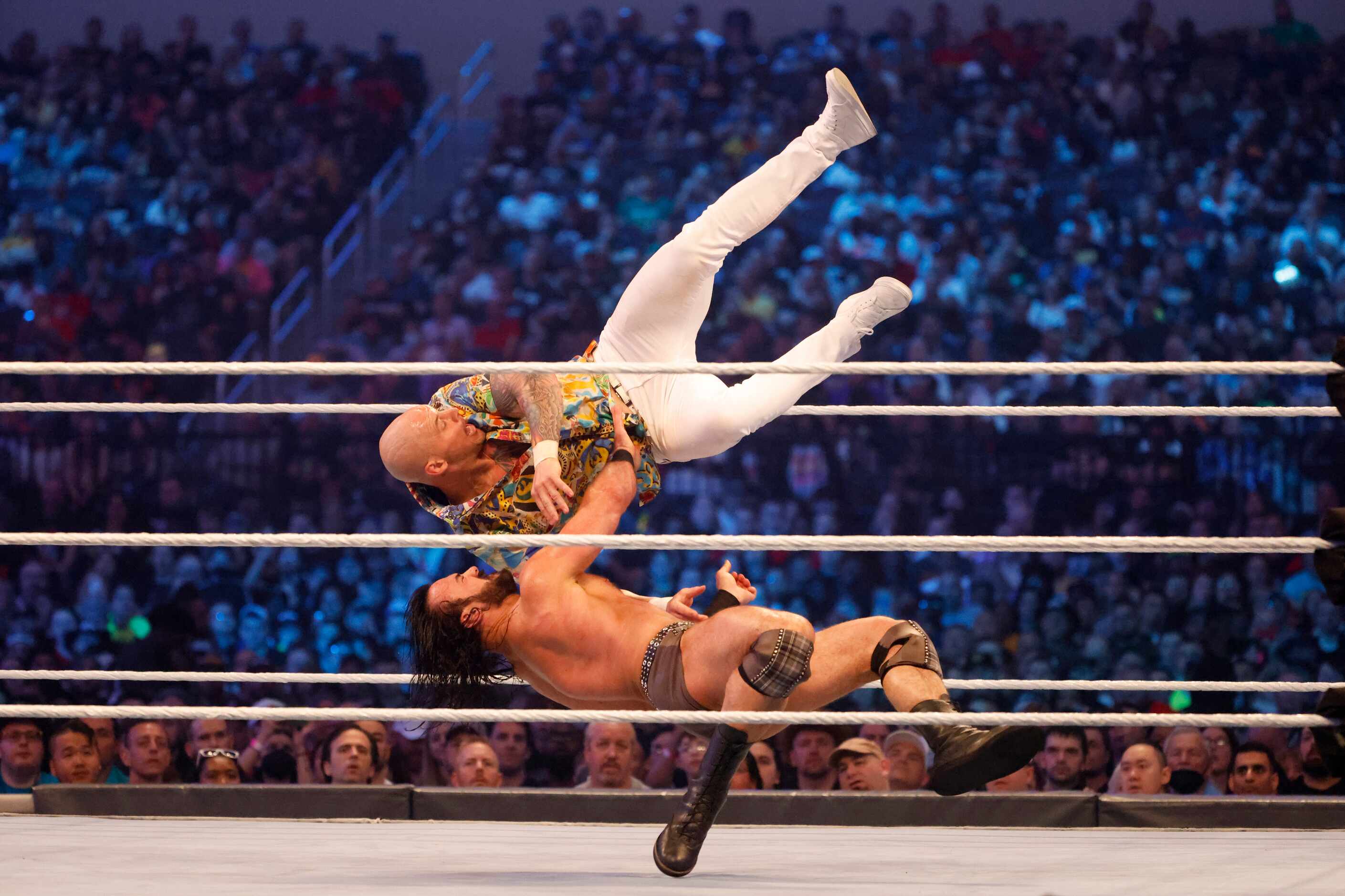 Drew McIntyre, bottom, flips Baron Corbin, top, during WrestleMania in Arlington, Texas on...