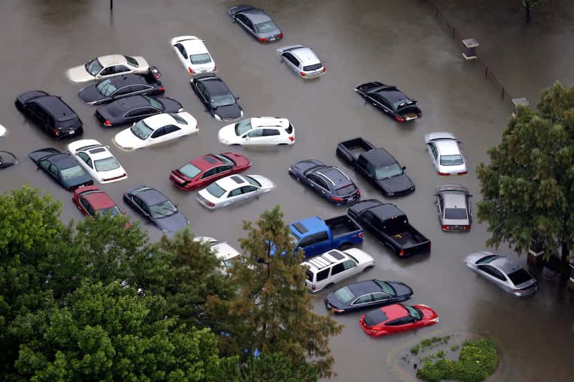 Flooded cars sit near the Addicks Reservoir in Houston after Harvey hit. (David J....