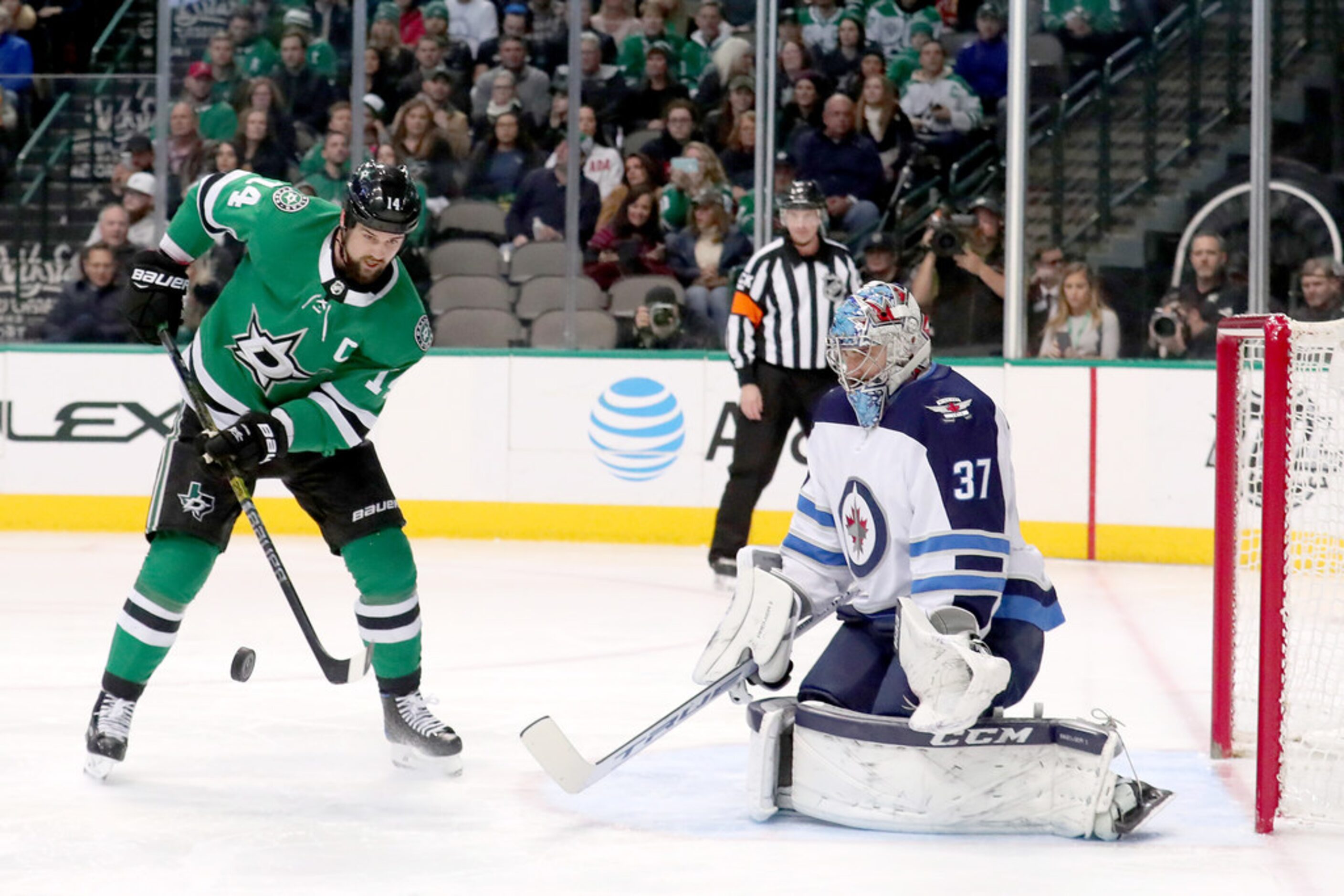 DALLAS, TEXAS - JANUARY 19: Jamie Benn #14 of the Dallas Stars controls the puck against...