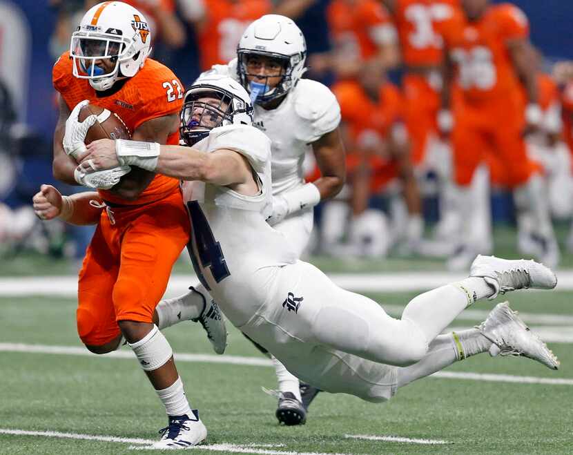 UTSA running back Tyrell Clay (22) tries to shake the tackle of Rice defensive end Brian...