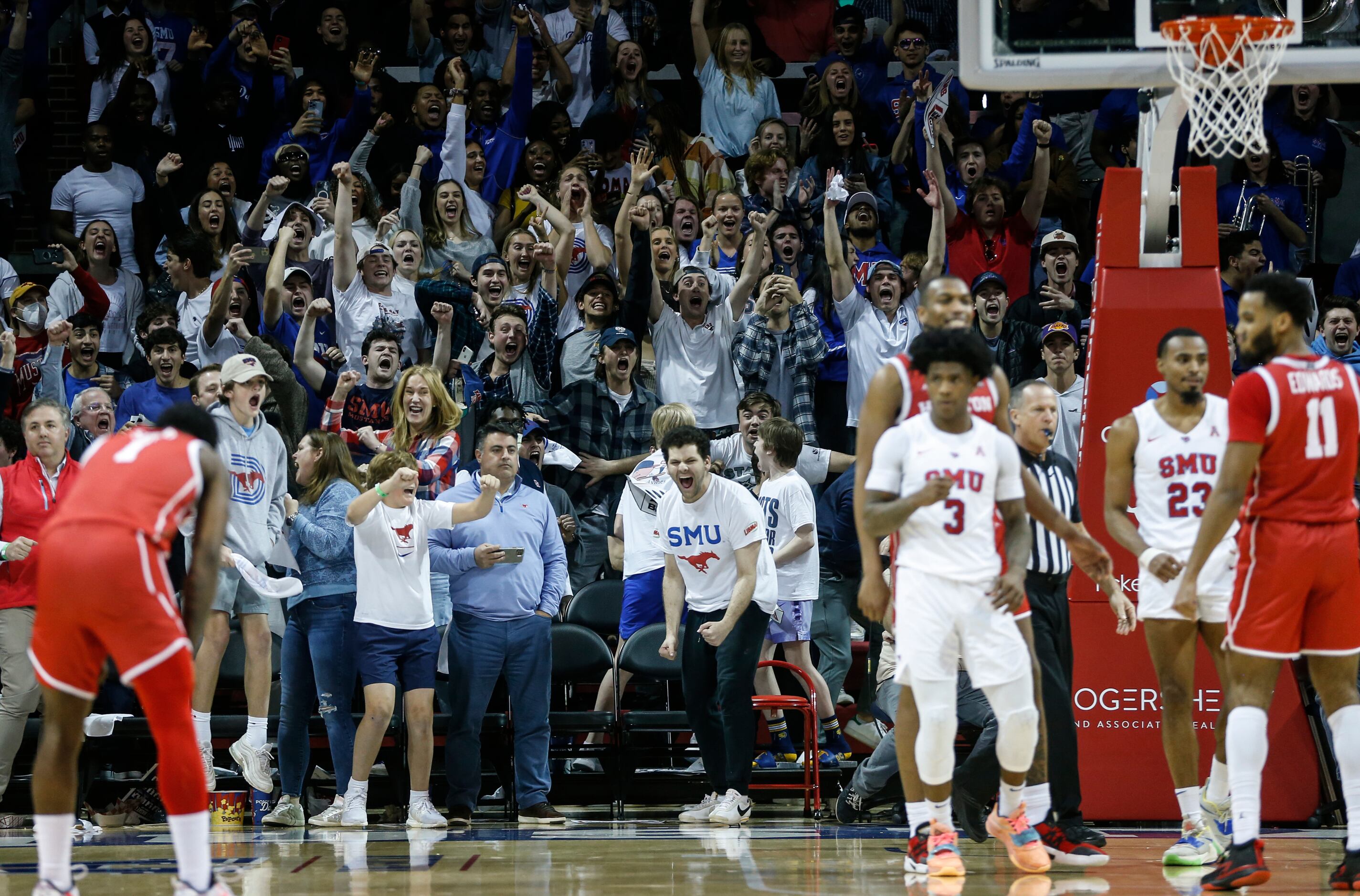 Southern Methodist University fans cheer as Houston Cougars guard Kyler Edwards (11) misses...