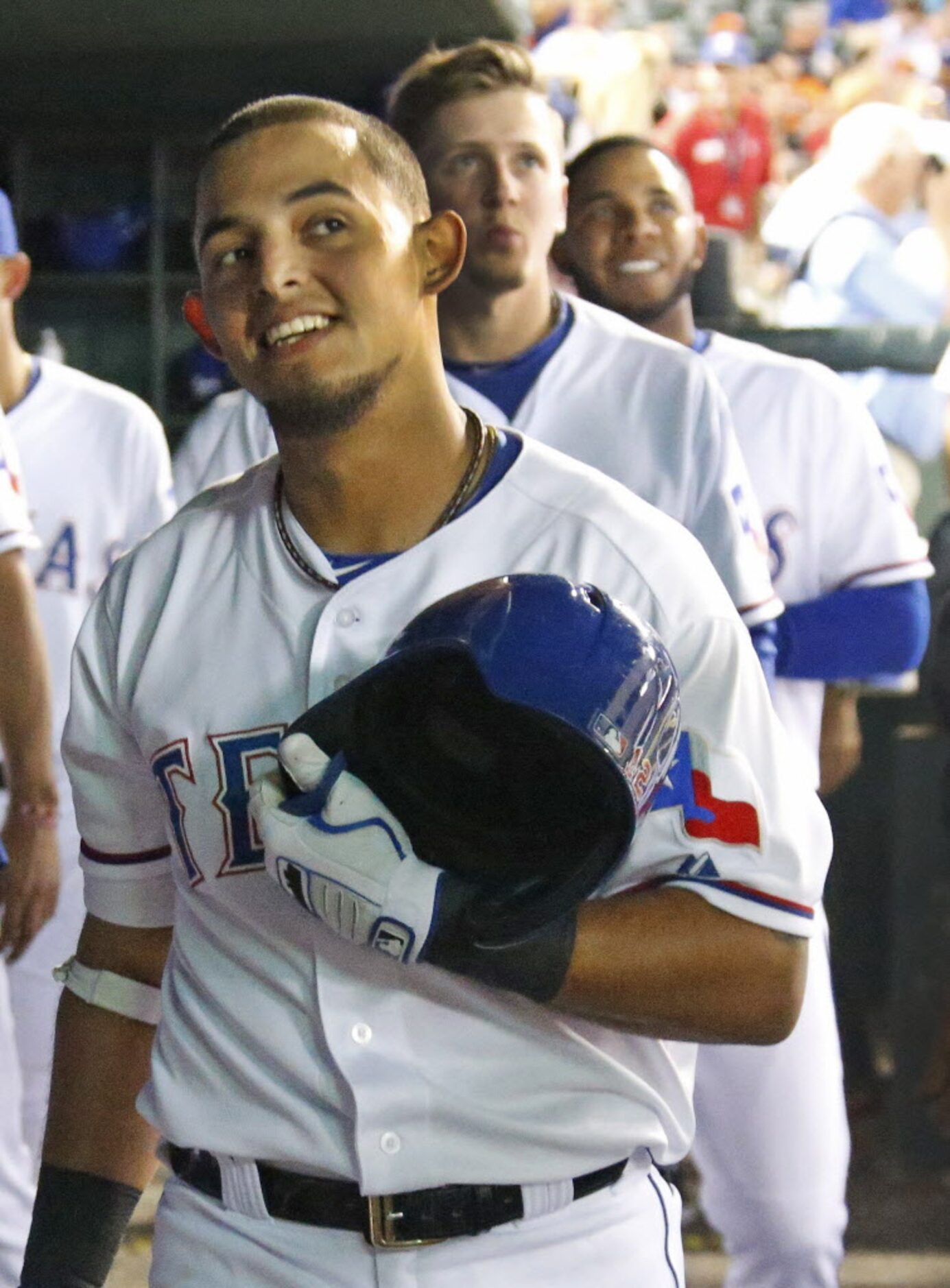 Texas Rougned Odor watches the replay of his his solo home run from the dugout in the...