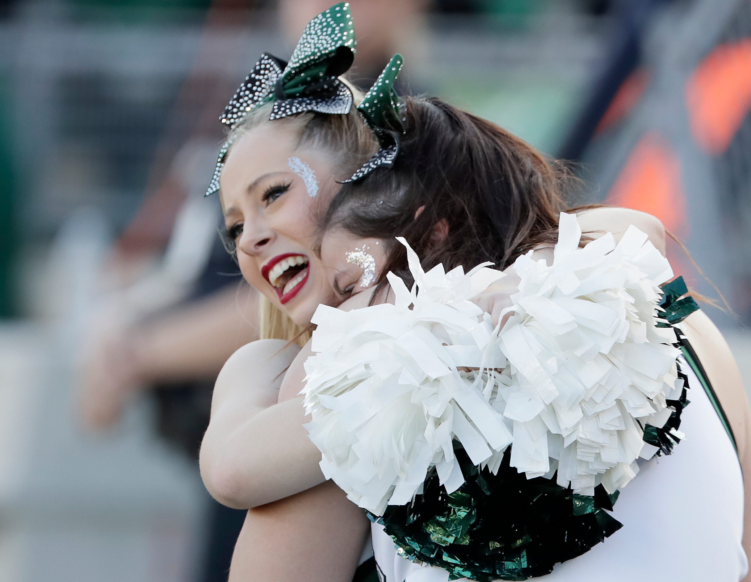 Waxahachie High School cheerleader Angela Presser (left), 18, embraces Brooklyn Kinder, 17,...