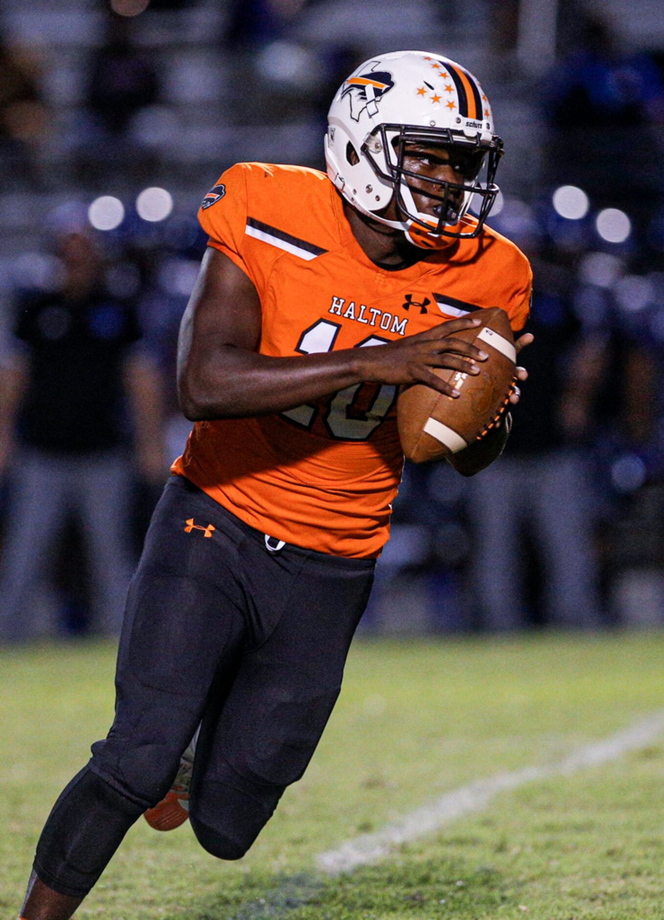 TXHSFB Haltom City senior quarterback Adam Hill (10) looks to pass during the first half of...