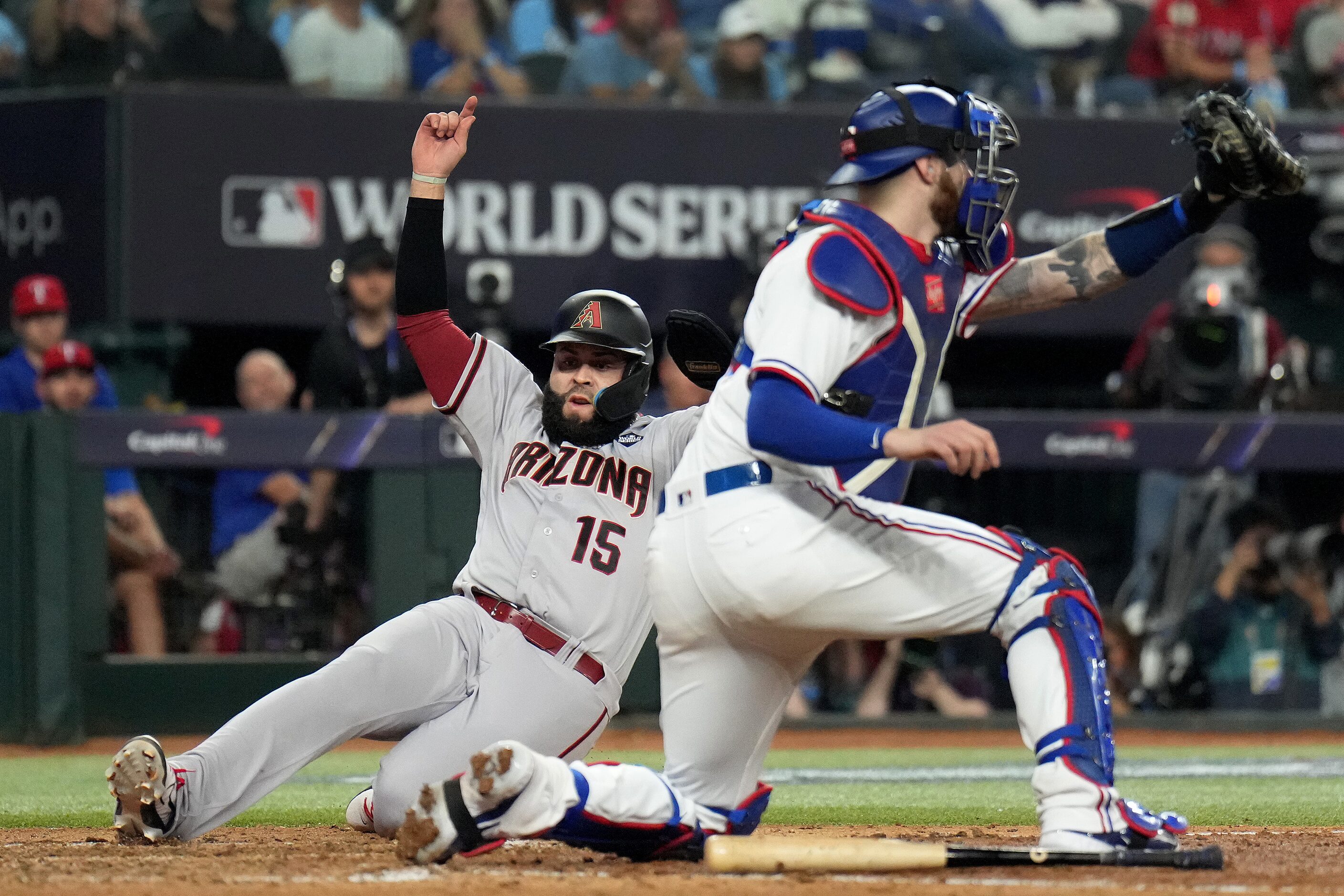 Arizona Diamondbacks' Emmanuel Rivera scores behind Texas Rangers catcher Jonah Heim on a...