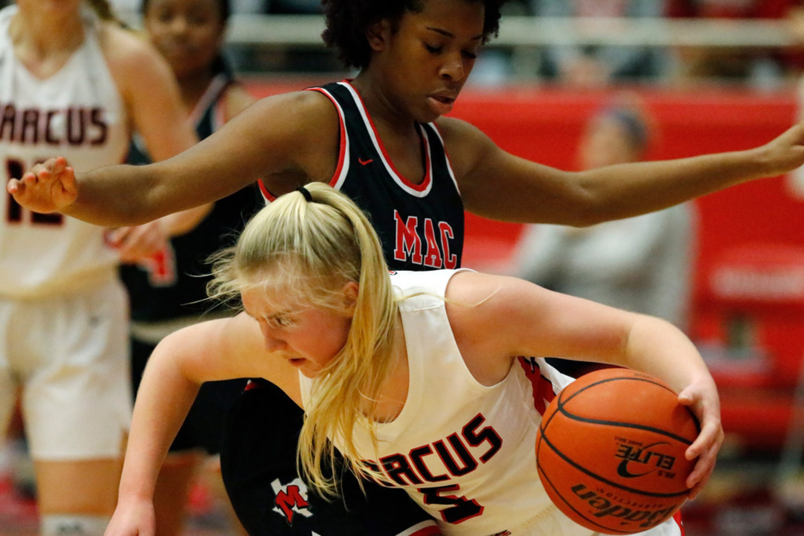 Flower Mound Marcus High School guard Abbie Barr (5) dribbles past Irving MacArthur High...