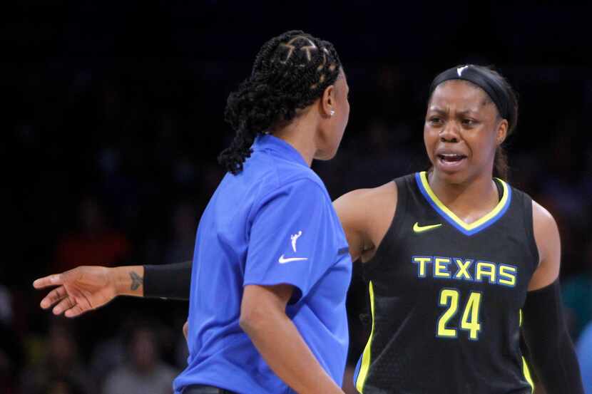 Dallas Wings guard Arike Ogunbowale (24) converses with head coach Vickie Johnson during a...