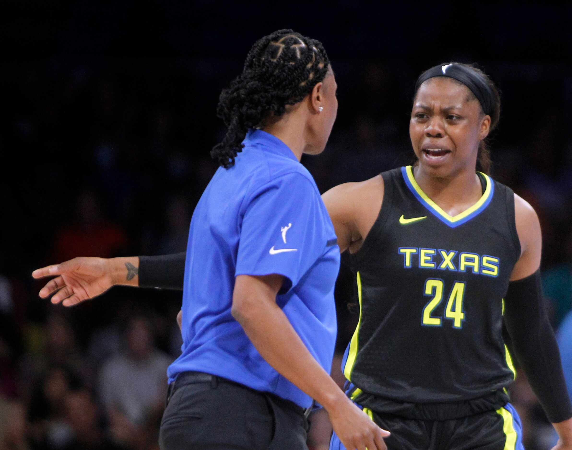 Dallas Wings guard Arike Ogunbowale (24) converses with head coach Vickie Johnson during a...