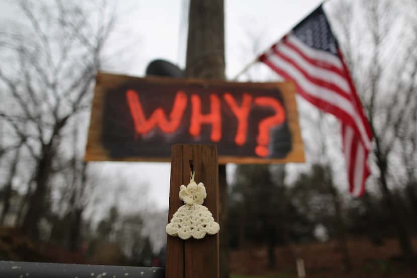 A knitted angel and a sign were hanging near a Newtown, Conn., cemetery last December. 