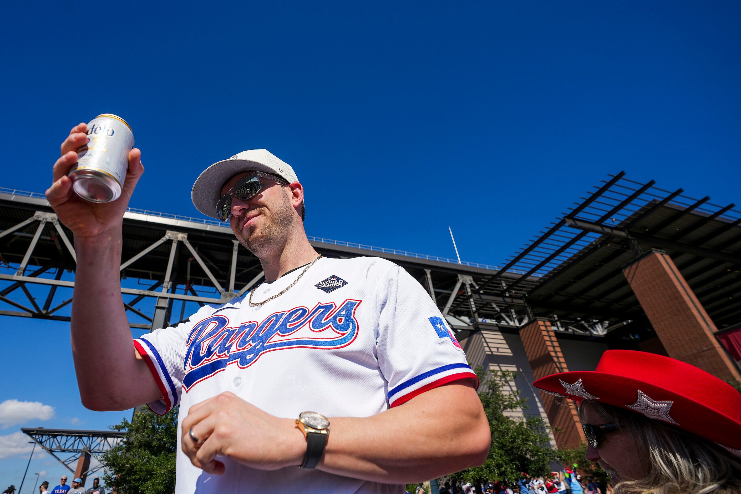 Designated hitter Mitch Garver raises a beer to the crowd during the Texas Rangers World...