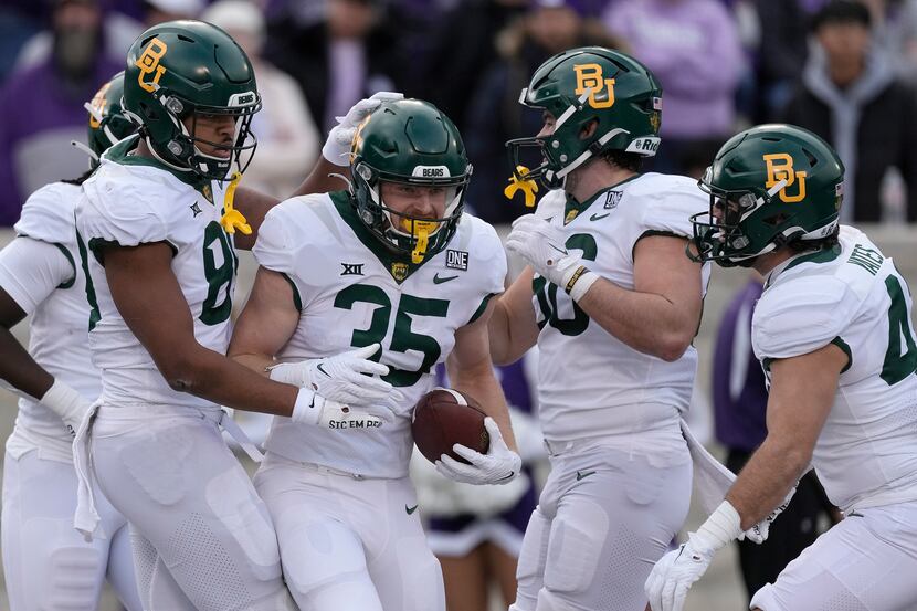 Baylor running back Dawson Pendergrass (35) celebrates with teammates after scoring a...