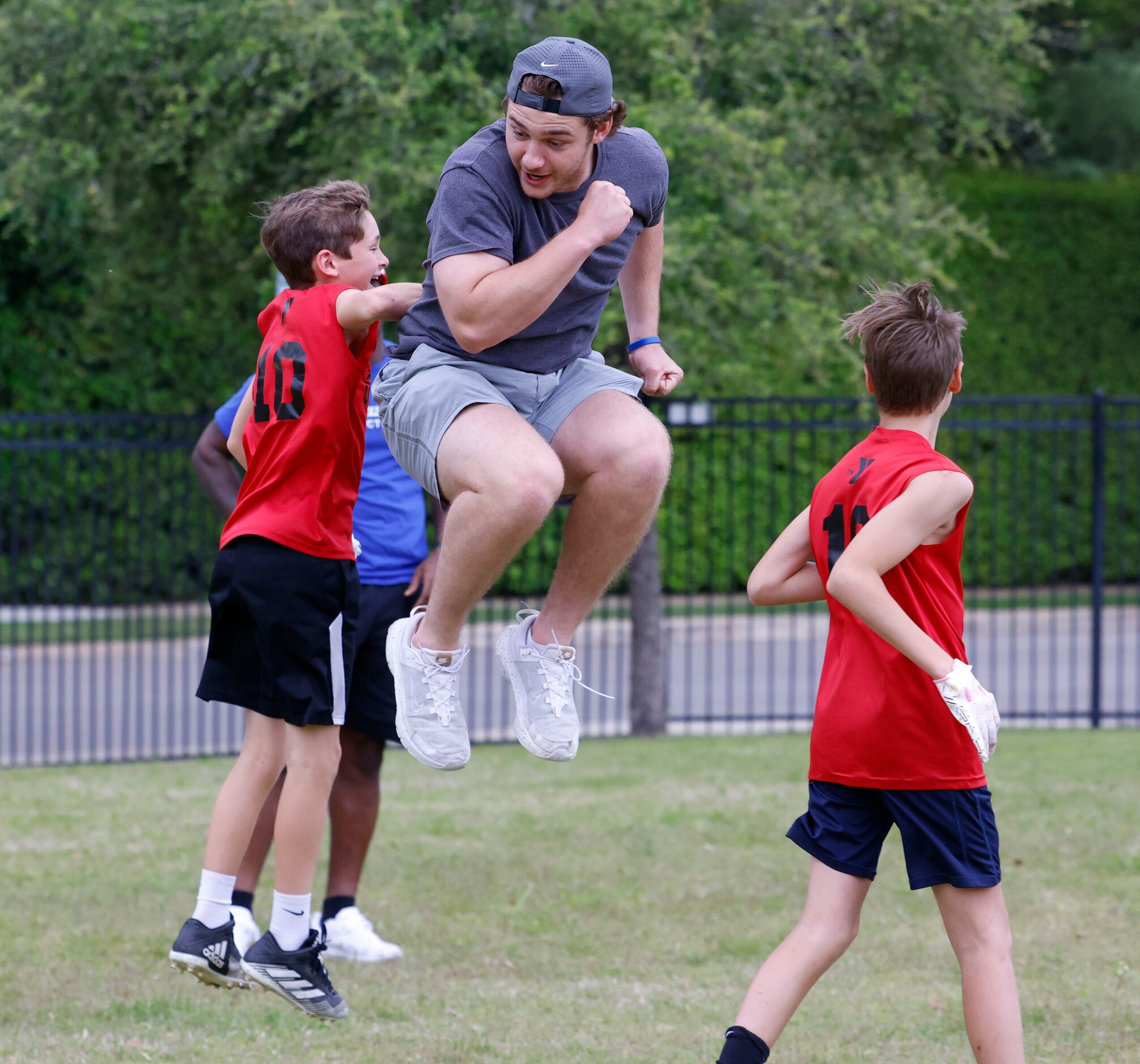 SMU QB Preston Stone (right) cheers with Henry McCallum during a special session of football...